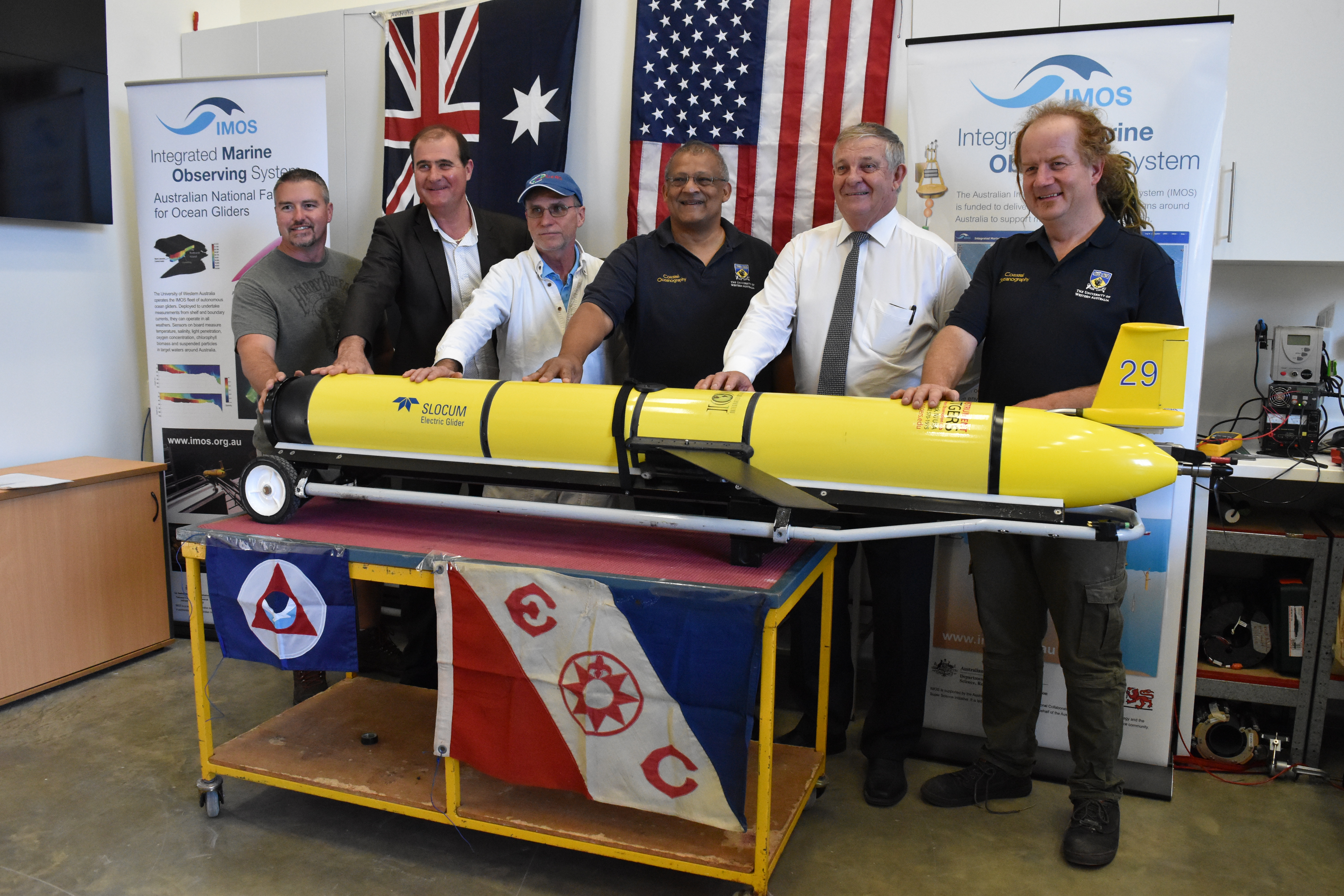 Glider RU29 is re-christened Challenger with Indian Ocean water at the University of Western Australia glider port in Perth, Australia.

L to R: Chip Haldeman, Rutgers glider pilot; Nick D’Adamo, Head – Perth Programme Office of the Intergovernmental Oceanographic Commission (IOC) of UNESCO and IOC IIOE-2 Coordinator; Scott Glenn, Rutgers Professor; Charitha Pattiaratchi, University of Western Australia Professor; Dr. Christopher Back, Liberal Senator for Western Australia and Chair, Senate Foreign Affairs, Defense & Trade Legislation Committee; and Dennis Stanley, UWA Glider Pilot.  On board the glider are flags from participating nations, including the United States, Australia, Sri Lanka, Indonesia, India, Spain, Germany, Brazil and South Africa, plus a challenge coin from NOAA Administrator, Dr. Kathryn Sullivan.