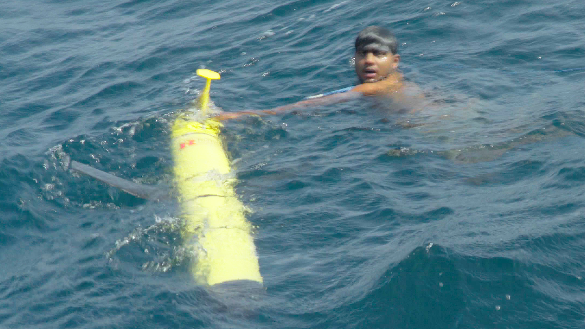 A swimmer from the Sri Lankan recovery vessel is the first to touch RU29 on September 30, 2017 after 330 days at sea.