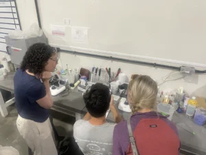 Michael Acquafredda and Collen Brust looking in a microscope.